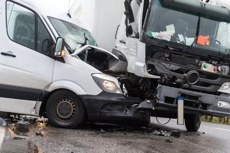 white van and large white truck in auto accident